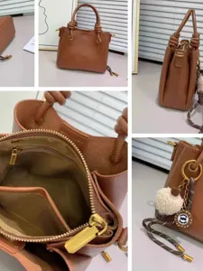 Classic brown leather handbag featuring stylish knotted top handles and secure zip closure.