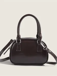 Classic brown bowling bag for women, stylish leather handbag with top handle and crossbody strap.