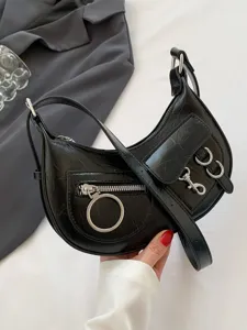 Black punk style crescent shoulder bag for women, edgy metal ring motorcycle crossbody bag.
