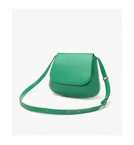 Green saddle bag for women, minimalist leather shoulder crossbody bag with adjustable strap.