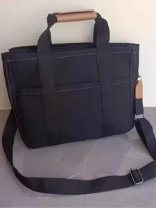 Black canvas tote bag multi-functional diaper bag stylish shoulder handbag for mothers daily use.