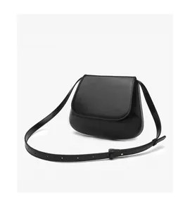 Classic black leather saddle bag detail, featuring an adjustable shoulder strap and clean flap.