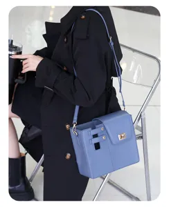 Detailed view of the stylish blue portable water bottle crossbody bag with secure lock.