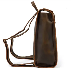 Close-up side profile of vintage brown leather backpack showing durable straps and texture.