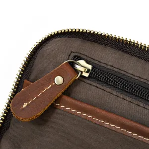 Vintage genuine leather travel bag detail close-up showing durable zipper and fine stitching.