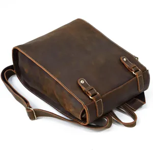 Vintage leather backpack detail showing genuine leather texture, strong stitching and brass hardware.