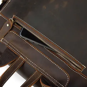 Close up detail of vintage crazy horse leather backpack zippered pocket with fine white stitching.