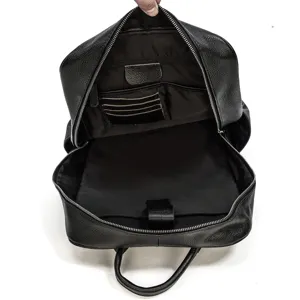 Black genuine leather business backpack interior detail showing large capacity storage compartments.