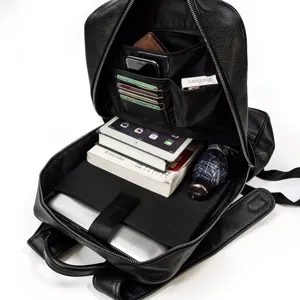 Detailed view of black genuine leather business backpack interior compartments and storage layout.