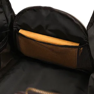Detailed view of travel duffel bag interior with mesh pocket and leather pouch organizer.