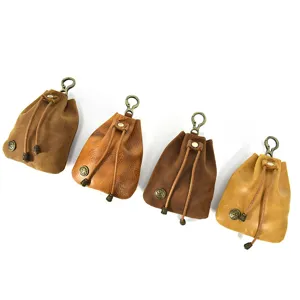 Close-up details of vintage genuine leather mini coin pouch, portable keychain storage bag.