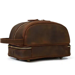 Close-up detail of vintage brown crazy horse leather travel toiletry bag with zipper.