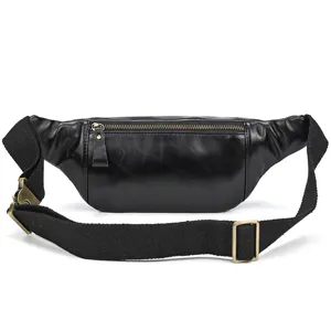 Detailed view of black genuine leather fanny pack with wide canvas strap and vintage hardware.