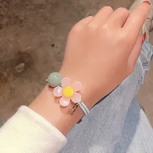 Chic pink flower hair tie with green bead, versatile cute bracelet hair band for women and girls daily wear.