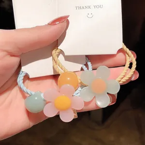 Detailed view of sweet floral hair tie with colorful resin beads and cute card packaging.