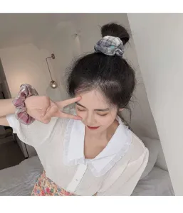 Plaid fabric hair scrunchie for women, cute daily ponytail holder and chic wrist bracelet accessory.
