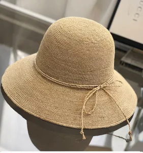 Handmade raffia sun hat for women, wide brim foldable beach straw hat for summer travel.