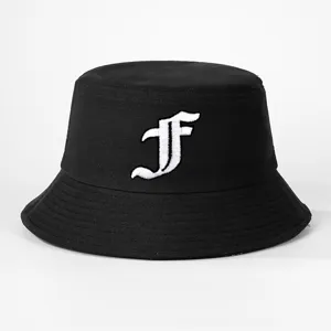 Close-up of black cotton bucket hat with white gothic letter embroidery detail for outdoor style.