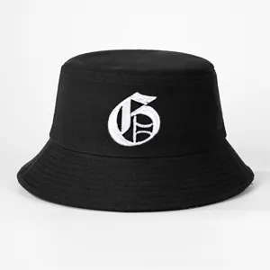 Close-up view of the black bucket hat featuring detailed white gothic letter embroidery.