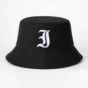 Black cotton bucket hat with white gothic letter embroidery, stylish and casual outdoor cap.