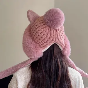 Detailed view of the cute pink plush knitted winter hat with cute ears and warm ear flaps.