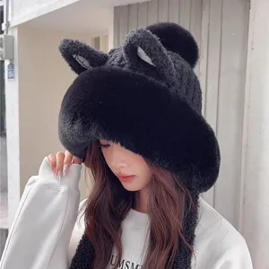 Close-up detail of cute black plush winter warm cat ear knitted hat with lovely fluffy pom-pom.
