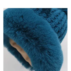 Detailed view of winter plush knitted hat showing soft faux fur trim and cozy textured yarn.