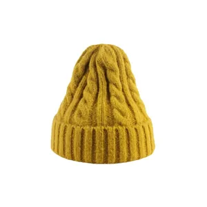 Chunky cable knit winter beanie hat in mustard yellow, warm and stylish pullover cap.