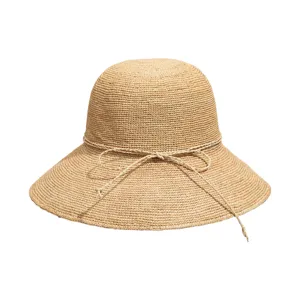 Handmade raffia sun hat detail showcasing fine woven texture and bow string design.