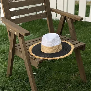 Resort style color-blocked straw hat with wide flat brim and frayed edges, perfect for summer.