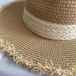 Fashionable frayed edge straw hat with woven band, perfect summer beach sun protection hat.