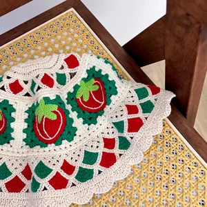 Handmade crochet strawberry bucket hat detail showing intricate red and green knit pattern.