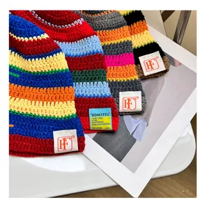 Detailed view of colorful striped knitted bucket hat, cozy wool material, streetwear style.