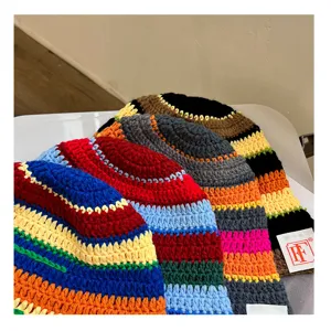Closeup detail of colorful handmade crochet stripe bucket hat knit beanie winter autumn style.