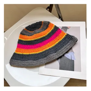 Detail view of a stylish autumn winter striped knit bucket hat, casual woolen colorful water bucket.