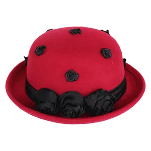 Red wool felt bowler hat detail showcasing black rose decorations and vintage rolled brim design.