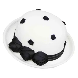 Detailed view of white wool felt dome hat featuring elegant black fabric roses and ribbon band.