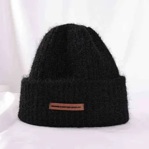 Thickened warm knitted winter beanie hat for women, soft cashmere style, solid black color detail view.