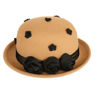 Close-up view of camel wool felt bowler hat featuring elegant black satin roses and ribbon.