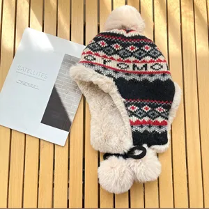 Women's winter warm knitted bomber hat with earflaps, fluffy pom poms and fair isle pattern.