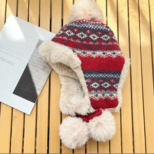 Cozy winter fleece-lined bomber hat with classic fair isle jacquard knit and playful pom-poms.