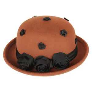 Close-up detail of the vintage brown wool felt hat adorned with elegant black fabric roses and ribbon.