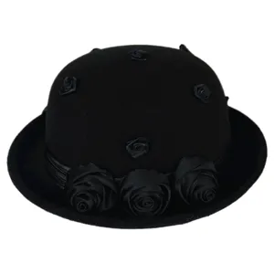 Detail close-up of the black wool felt vintage bowler hat showcasing exquisite black fabric roses.
