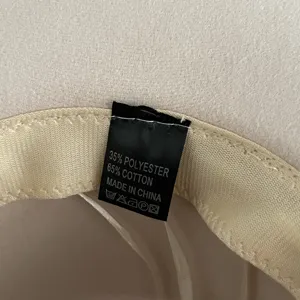 Detailed view of the inner hat label showing material composition and washing instructions clearly.