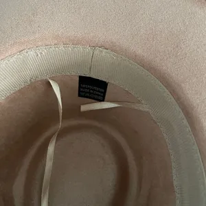 Detail view showing the inner sweatband and size label of the vintage faux suede fedora hat.