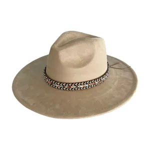 Close-up detail of the wide-brim suede fedora hat, featuring a stylish woven band decoration.
