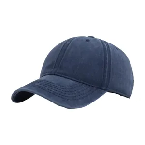 Close-up detail of the washed cotton baseball cap, showing texture, curved brim and eyelets.