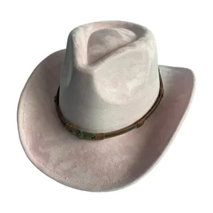 Gros plan sur le chapeau de cowboy occidental en suédine rose avec détail de tête de mort.