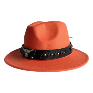Detailed view of the vintage orange fedora hat featuring a black leather band with silver bull skull.