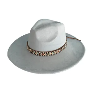 Detailed view of the grey wide-brim suede fedora hat featuring a woven ethnic pattern band.